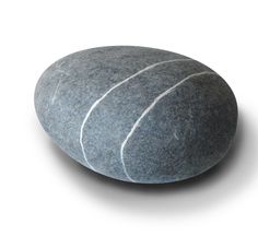 a gray rock with white lines on the top and bottom, sitting in front of a white background