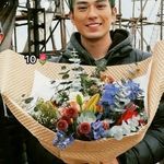 a man holding a bunch of flowers in his hands