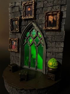 a fake castle with pictures on the wall and green light coming from it's windows