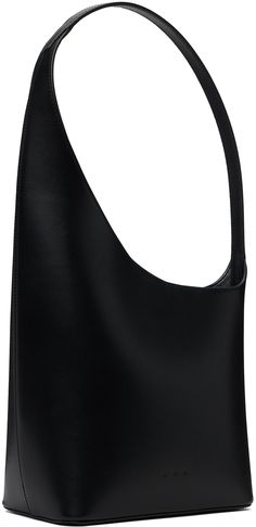 Buffed calfskin shoulder bag in black. · Integrated shoulder strap · Logo embossed at face · Magnetic closure at asymmetric throat · Patch pocket at interior · Buffed faux-leather lining · H14 x W9.5 x D4 · Total height: H16 Supplier color: Black Evening Faux Leather Hobo Bag With Removable Pouch, Black Textured Leather Structured Shoulder Bag, Black Structured Textured Leather Shoulder Bag, Structured Black Textured Leather Shoulder Bag, Modern Faux Leather Shoulder Bag For Evening, Business Shoulder Bag In Textured Faux Leather, Business Faux Leather Shoulder Bag With Textured Finish, Modern Evening Faux Leather Shoulder Bag, Evening Structured Shoulder Bag With Adjustable Strap