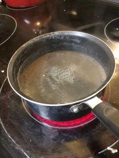 a frying pan filled with boiling water on top of a stove