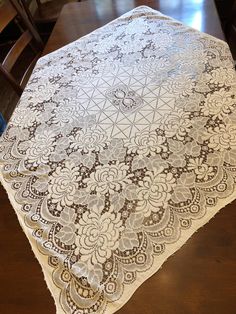 a table with a white and brown doily on it