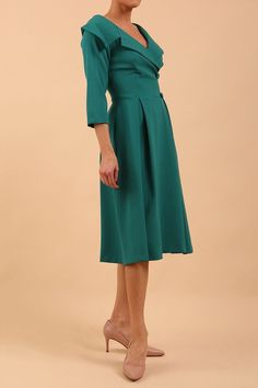 Steal the limelight with this beautiful 3/4 sleeve swing dress, which is perfect for Weddings! Made from a luxury crepe fabric and hidden pockets in the skirt ensuring that it is comfortable to wear and will last for years to come. The dress features a beautiful cross over V-neckline that adds a touch of elegance and sophistication to the overall design.  It has a large blazer style collar and concealed back zip. This dress is available in  pale blue, green, sandy beige or navy Model wears a siz Dress Mother Of The Bride, Diva Dress, Brunette Models, Oversized Collar, Blazer Fashion, Collar Dress, Mother Of The Bride Dresses, Cocktail Dresses, Swing Dress