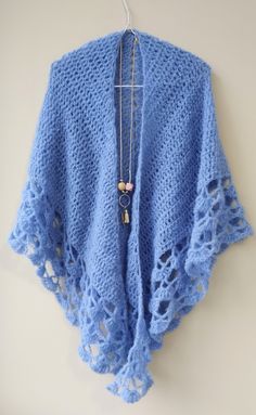 This handmade blue crochet shawl is here to add a touch of vintage style to your wardrobe. Crafted with a luxurious blend of alpaca and silk, it feels as soft and cozy as it looks elegant.  Whether you drape it over your shoulders at a special occasion or wrap it around yourself on a chilly evening, this shawl will be your go-to accessory for a timeless, sophisticated look.  With its intricate crochet detail and the exquisite quality of alpaca and silk, this piece is a must-have for anyone who appreciates the beauty of handmade creations.  Elevate your style and stay warm in a uniquely elegant way with this stunning blue crochet shawl! 🍀Material: exclusive mix of brushed, superfine alpaca and subtle shiny silk 🍀Color: Pacific Blue 28  (see other colors in the pictures)  🍀Measurements: L Crochet Alpaca, Alpaca Shawl, Intricate Crochet, Blue Shawl, Winter Wrap, Cozy Wrap, Bohemian Women, Blue Crochet, Wool Wrap