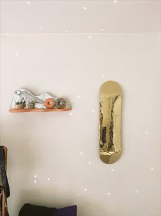 a skateboard mounted to the side of a wall next to a chair and table