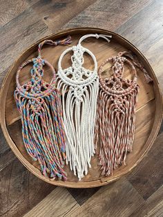 four macrame dream catchers on a wooden tray