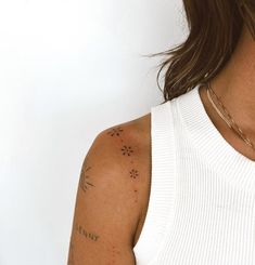 a woman with tattoos on her arm and shoulder