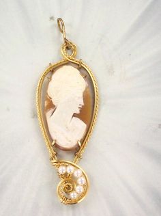 THE BEAUTY OF CAMEOS Amazing  -----30mm  hand carved Large   cameo pendant by master carvers in Italy.  Sculpted in 14kt Rolled Gold  --------a custom design.  30mm  Oval  shaped shell with high detail which cannot be seen in the photograph.  The Cameo -- Intricate detail that you can see and notice.  The cameo length --- 2  1/4   INCHES LOTHE CAMEO HASS A STRING OF PEAARLS ON IT Very delicate and intricate in appearance and will get you noticed!   One of a kind handcrafted piece of jewelry that anyone will look good in Absolutely amazing something that you will be proud to wear AAA Quality ---   CARVED IN ITALY BY MASTER CARVERS hand sculpted  14kt Rolled Gold  pendant  setting  You won't be disappointed with this cameo pendant ABOUT MY JEWELRY This is wire sculpted Jewelry all made by ha Jewelry With Pearls, Sculpted Jewelry, Cameo Jewelry, Cameo Necklace, Cameo Pendant, Gold Wire, Pendant Set, Silver Wire, Gold Pendant