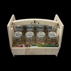 six glass jars in a wooden holder