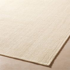 a white rug on top of a wooden floor