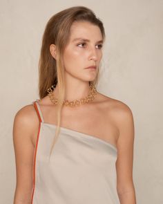 Thorn chain necklace by Kiko Kostadinov. Ornamental necklace formed of interlocking orbital hoops. Spiked interior thorns add further tactile intrigue to this superlatively contemporary accessory. Born in Bulgaria and based in London, Kiko Kostadinov launched his eponymous womenswear line in 2018, delving into an avant-garde aesthetic with innovative fabrics and architectural silhouettes. With Australians Laura and Deanna Fanning at the creative helm, the collections bring to life modern feminit Modern Party Necklaces With Chain Strap, Yellow Gold Jewelry With Chain Strap For Evening, Modern Chain Link Necklace For Party, Chic Evening Jewelry With Chain Link, Minimalist Chain Necklace For Evening, Modern Delicate Chain Necklace For Party, Modern Link Necklace With Chain Strap, Modern Link Chain Necklace For Party, Modern Gold Necklace With Chain Strap