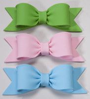 three different colors of bows on a white background, one is pink, the other is blue