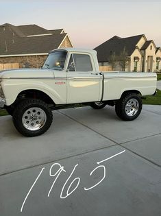 a white truck parked on top of a driveway