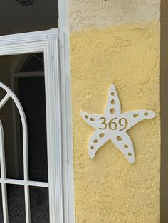 a white starfish on the side of a yellow building