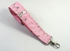 This cute lanyard has beautiful cute peanuts on pink with hugs. It is perfect for any occasion. You can leave me a convoy if you need a different size. You can have a wardrobe of lanyard to match your outfit. This lanyard is made of soft 100% cotton fabric to give a comfortable feel around your neck. This lanyard is easy to take care. You can spot clean and throw in a washer and hang dry. If you want you can iron and it is ready to use. These lanyards are perfect if you have metal allergy. Each of these lanyards will have a slight different pattern depending on where fabric is cut on pattern. This lanyard measures 21 inches long on one side and it is 3/4 inch wide or 42 inches long all over around neck. Multiple orders are welcome and I take custom orders too on all my lanyards. All the pr Fun Pink Badge Holders For Gift, Pink Lanyard With Key Leash For Gift, Cute Pink Badge Holder As Gift, Cute Pink Badge Holders For Gift, Cute Pink Badge Holders As Gift, Fun Pink Badge Holders, Cute Lanyard, Cute Lanyards, Fabric Lanyard