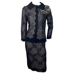 Dolce and Gabbana Black Silk and Gold Lace Skirt Suit - Size 40 This gorgeous skirt and jacket are made of 2 black silk chiffon layers with a gold lace fabric inserted in between creating an elegant combination. The jacket has a rounded 3.5” black satin collar, round neckline, 4 hidden snaps down the front closure area, bracelet sleeve and a removable large camilia brooch. Th skirt has a 1” grosgrain ribbon for a waistband with a hidden snap, 6” zipper and 7” kick pleat. The jacket is a size 40 and the skirt a size 38. The ensemble is in excellent condition and the measurements are: Jacket: Shoulder to Shoulder 15” Bust 35” Waist 32” Hips 36” Sleeve length 21.5” Length from center back 23” Skirt: Waist 25.5” Hips 35” Length 25” Gold Lace Fabric, Dolce And Gabbana Suits, Bracelet Sleeve, Skirt And Jacket, Kick Pleat, Gold Lace, Dolce & Gabbana, Skirt Suit, Silk Chiffon