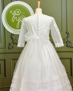 A gorgeous traditional white and long sleeves dress for girls to wear on her communion day. This is a stunning piece made with a white organza and with handmade details throughout the gown; it has pleats, laces, and elegancy. It has buttons and a bow on the back. Made in Spain Does not include crinoline Dry Clean Lining: 100% cotton Final Sale, no exchanges nor returns will be accepted Elegant Organza Dress For First Communion, White Organza First Communion Dress With Ruffles, Elegant Tulle First Communion Dress, Long Sleeve Baptism Dress With Ruffles For First Communion, Elegant Organza First Communion Dress, Elegant First Communion Dress With Lace Sleeves, Elegant First Communion Gown With Lace Sleeves, Elegant Gown With Lace Sleeves For First Communion, Organza Baptism Dress With Lace Bodice For Confirmation