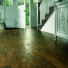 an empty room with wooden floors and white doors