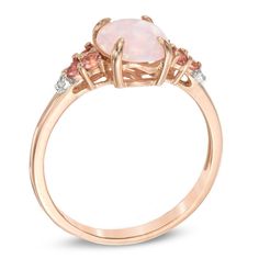 Win the heart of the October birthday girl with this colorful gemstone fashion ring. Expertly crafted in sterling silver with 14K rose gold plate, this look features a 9.0 x 7.0mm oval-shaped iridescent pink lab-created opal. Trios of shimmering pink tourmalines and single white lab-created sapphires flank the center. Buffed to a brilliant luster, this design suits her sweet style. This ring is available in size 7 only. 14k Rose Gold Jewelry With Gemstones, Rose Gold Multi-stone Promise Ring, Rose Gold Opal Ring Fine Jewelry, Oval Rose Gold Rings With Gemstone Accents, Rose Gold Rings With Gemstone Accents As Gift, Gift Rose Gold Rings With Gemstone Accents, Rose Gold Sterling Silver Birthstone Ring, 14k Rose Gold Ring With Center Stone, Rose Gold Gemstone Rings In 14k