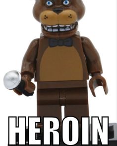 there is a lego bear with a hat and bow tie on it's head