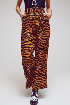 Make a fierce fashion statement with our Animal Print Straight Leg Pants with Wide Buckle Belt. These pants feature a full length and an eye-catching animal print, adding a touch of boldness and personality to your outfit. Designed with a relaxed fit and a straight leg, these pants offer both comfort and style. The tailored construction ensures a flattering silhouette, while the high waist rise adds a trendy and figure-enhancing effect. The pants come with a wide buckle belt made of the same fab