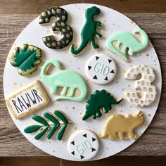 decorated cookies are arranged on a white plate