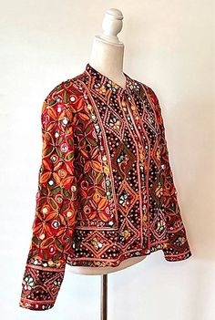 This exceptional cotton jacket with beautiful old embroidery is one-of-a-kind, collector's item. Fully embroidered on all sides, mixed colors which may be worn in all seasons. 3/4 sleeves, fully lined, open duster style. A traditional complex pattern is created from the embroidery. Designed to be worn open, easy fit. This jacket can be worn over a long silk tank dress, palazzo pants, slacks, skirt and even jeans. Jacket crafted by skilled Indian Guajarati Artisans. This jacket represents the true craftsmanship of the region and an object of art. It Is perfect for any event and great for travel. The traditional embroidery patterns are perfect for the boho look of the season. Consider purchasing for a special gift; wedding, anniversary, holiday, etc. One Size: Fits US size 8-12 (Medium) . Ch Red Folk Cotton Outerwear, Traditional Cotton Outerwear With Intricate Embroidery, Red Embroidered Folk Outerwear, Red Folk Embroidered Outerwear, Traditional Cotton Outerwear With Multicolor Embroidery, Folk Style Red Outerwear For Festivals, Red Folk Style Outerwear For Festivals, Red Cotton Outerwear For Festivals, Red Cotton Festival Outerwear