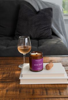 a glass of wine sitting on top of a wooden table