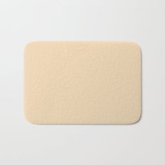 a close up of a white bath mat