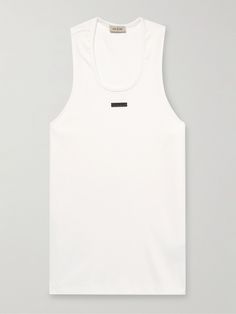 Fear of God's tank top is appliquéd with the label's signature logo patch on the chest. Cut from ribbed stretch-cotton, it has a relaxed shape emphasised by wide armholes and an elongated hem.. Stretch Ribbed Tank Top For Streetwear, Stretch Cotton Ribbed Vest, Sporty Ribbed Cotton Tank Top, White Ribbed Cotton Vest, Sports Cotton Ribbed Tank Top, Sports Ribbed Cotton Tops, Ribbed Cotton Sports Tops, Summer Cotton Tops With Logo Patch, Ribbed Cotton Tank Top For Sports