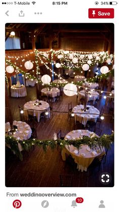 an overhead view of tables with white linens and lights