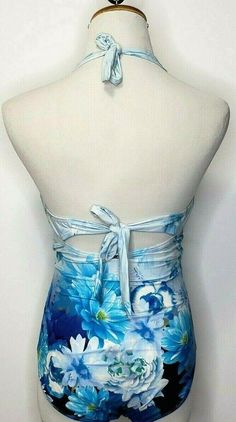 a mannequin with blue and white flowers painted on it's sides, tied to the back