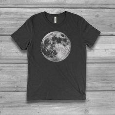 Women's graphic T-shirt with a Full Moon screen printed design. Unisex sizing with a super soft hand and comfortable fit.  See image chart for colors and size.  FIT NOTE & COLOR - See image size chartUnisex Fit: Runs large / Longer Length We suggest SIZING DOWN one from your normal women's size.Chest measurement shown on chart is actual garment size. PLUS SIZE for most 0X = L relaxed fit1X = XL relaxed fit2X = XXL relaxed fit-  Bella 3.8 oz  Super Soft hand / light weight -  Tri Blends:  50% Black Moon Print Graphic Tee, Black Graphic Tee With Moon Print, Black Short Sleeve T-shirt With Moon Print, Casual Moon Print Short Sleeve T-shirt, Black Cotton T-shirt With Moon Print, Relaxed Fit Moon Print Short Sleeve Tops, Black Moon Print Crew Neck Top, Black Crew Neck Top With Moon Print, Black Short Sleeve Shirt With Moon Print