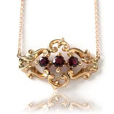 "Garnet gemstones are the birthstone of January. The beautiful stones have been extremely popular since the 18th and 19th century, the gemstones are the ideal gem for that extravagant effect. Victorian garnets were faceted and clustered together for maximum effect, they are very romantic.  Antique Victorian pendant featuring Garnets set in a warm ornate 9ct yellow gold setting. The pendant hangs on a new 9ct gold chain. The piece was converted from a brooch into a pendant by our expert Master Go Antique Ruby Necklace For Formal Occasions, Victorian Ruby Necklace For Formal Occasions, Antique Ruby Gemstone Necklace, Classic Garnet Necklace For Formal Occasions, Victorian Style Gemstone Necklaces For Anniversary, Classic Garnet Gemstone Necklace, Classic Garnet Birthstone Necklace, Victorian Birthstone Necklaces For Anniversary, Victorian Birthstone Necklace For Anniversary