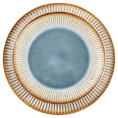 a blue and white plate with lines on it's rim, against a white background