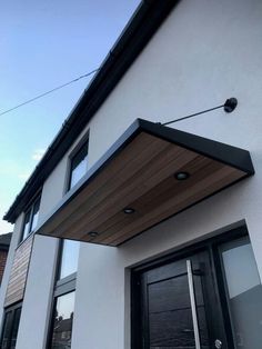 the outside of a house with an awning over it's door and windows