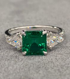 The Center stone is an Absolutely Exceptional Natural GRS Certified 1.76 Ct Colombian emerald that has received the *Muzo Green* & "Old Mine" awards as well as the "vibrant brilliancy" award on its certificate notating its Outstanding Quality , and also it has received insignificant oil (it measures 7 x 7 mm) & is a spectacular example of what a true Top GEM Quality investment grade Muzo old mine emerald should look like. It checks all the boxes for Colombian emeralds with Incredible unbeatable Jewerly Designs, Vvs Diamond, Goddess Of Love, Colombian Emeralds, White Gold Ring, Gem Stone, Brilliant Cut Diamond, White Gold Rings, Gold Ring