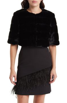 A glam finish to your party-going look, this cropped-sleeve bolero is crafted of soft and lustrous faux fur carved into plush channels. 18 1/2" length (size Medium) Hook-and-eye closure at neck Elbow-length sleeves Lined 100% polyester faux fur Dry clean Imported Special Occasion Chic Faux Fur Coat For Party, Elegant Faux Fur Outerwear For Night Out, Party Fur Coat With Faux Fur Trim, Party Faux Fur Outerwear In Mink, Chic Evening Fur Coat With Faux Fur Trim, Glamorous Fitted Faux Fur Coat, Chic Cropped Jacket For Evening In Winter, Chic Cropped Jacket For Winter Evenings, Elegant Mink Outerwear For Party