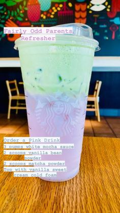 a starbucks drink sitting on top of a wooden table