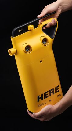 a person holding a yellow case with eyes on it