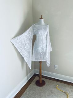 a white dress on a mannequin in a room