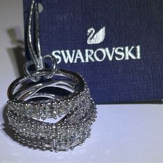 Swarovski Wrap Ring Best Offer Excepted Intricate And Opulent, This Marvelous Swarovski Ring Reinterprets The Spiral Trend Magnificently. Gently Curving Lines Of White Stones Of Various Sizes In Round, Square, And Tapered Baguette-Shapes Sparkle Brilliantly In Many Facets. Complemented By A Shimmering Finish, The Elegant Design Makes It Perfect For Dressing Up Your Style, Adding A Radiant Touch Of Glamor To Your Look. Collection: Twist Color: White Material: Rhodium Plated, Zirconia Sold As Is P Diana Ring, Swarovski Crystal Rings, Swarovski Ring, The Spiral, White Stones, Bow Ring, Gold Cocktail Ring, Contemporary Ring, Gold Cocktail