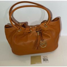 Michael Kors East West Leather Ring Tote Tangerine Orange Color Handbag Is Medium In Size And Brand New With Tags. Soft Luxurious Leather Bag W/ Leather Tassel, Mk Logo Charm, Top Magnetic Closure, Cinched Top With Grommet Detail, Logo Print Lining, Interior Zip Pocket, Cell Phone Pocket, Extra Pockets. The Measurements Are 13"W X 10"H X 8"D With An 8" Drop. The Msrp Is $348.00 Brand New With Tags Fast Shipping! Great Valentines Day Gift! Fast Shipping! Orange Leather Shoulder Bag With Gold-tone Hardware, Classic Orange Bag With Gold-tone Hardware, Orange Tote Shoulder Bag With Gold-tone Hardware, Orange Leather Bags With Branded Hardware, Orange Shoulder Bag With Dust Bag Included, Michael Kors Cognac Shoulder Bag For Shopping, Orange Shoulder Bag With Gold-tone Hardware For Shopping, Orange Tote Bag With Gold-tone Hardware, Designer Orange Bags With Gold-tone Hardware