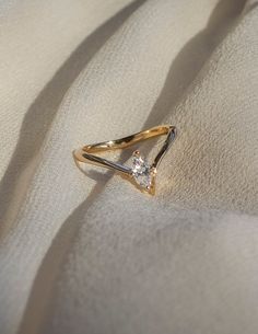 a diamond ring sitting on top of a white cloth