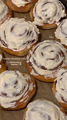 several cinnamon rolls with white frosting on top