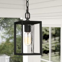 an outdoor light hanging from a porch