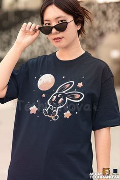 Space Bunny - Cute Moon Rabbit T-Shirt Artwork by Sarah Richford ( TechraNova )   I hope you enjoy this original artwork of mines!  If you have any questions, please feel free to contact me! Otherwise, PLEASE READ the description below before you place your order. --- CUSTOM-PRINTED JUST FOR YOU --- Your T-shirt is custom-printed just for you! We use the latest in DTG (Direct-to-Garment) technology so the printed artwork will have super sharp details and vibrant colors. The printed shirt will fe Cute Short Sleeve T-shirt With Star Print, Cute Star Print Crew Neck Top, Cute Crew Neck Top With Star Print, Space Bunny, Space Bunnies, Moon Rabbit, Galaxy Shirt, Space Galaxy, In The Stars