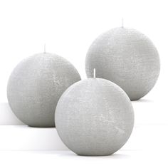 three white balls sitting next to each other