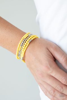 An array of decorative silver, polished yellow, and smooth silver beads are threaded along stretchy bands around the wrist, creating colorful layers. Yellow Bracelet, Stacked Jewelry, Paparazzi Accessories, Stretchy Bracelets, Paparazzi Jewelry, Trendy Accessories, One Set, Boutique Jewelry, Necklace Earring Set