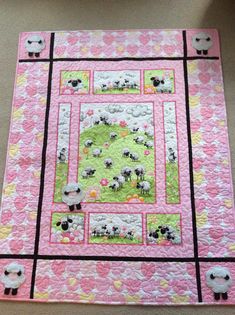 a pink quilt with sheep on it